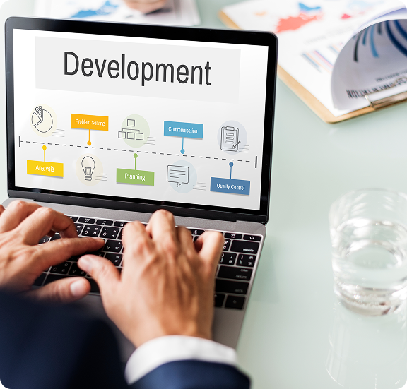 Hands on a laptop showing a development workflow on screen.
